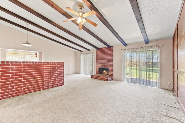 unfurnished living room with a brick fireplace, vaulted ceiling with beams, ceiling fan, a textured ceiling, and carpet floors