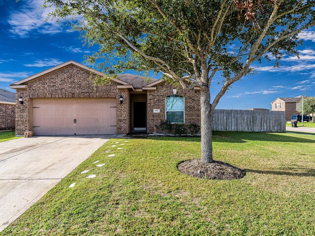 view of front of property with a garage and a front lawn