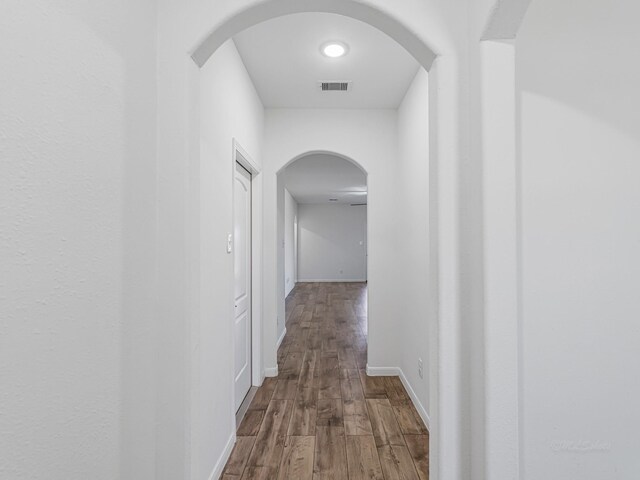 hall with hardwood / wood-style floors