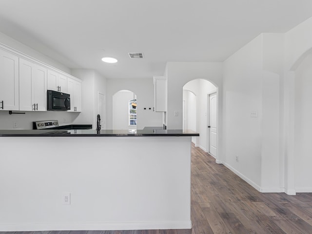 kitchen with range with electric stovetop, kitchen peninsula, white cabinets, and hardwood / wood-style flooring