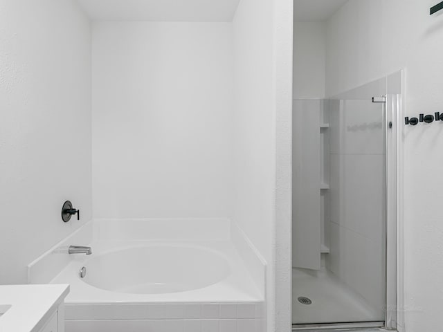 bathroom featuring vanity and shower with separate bathtub