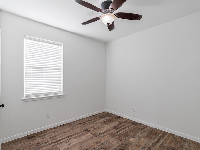 empty room featuring ceiling fan and dark wood-type flooring