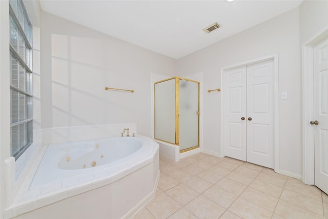 bathroom featuring tile patterned flooring and shower with separate bathtub