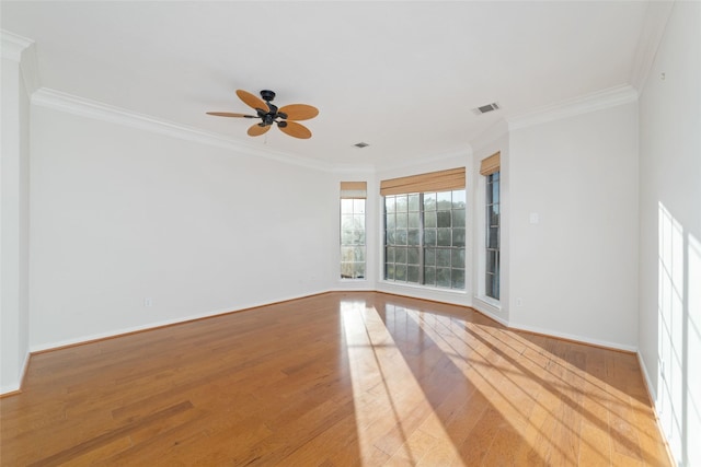 empty room with crown molding, hardwood / wood-style floors, and ceiling fan