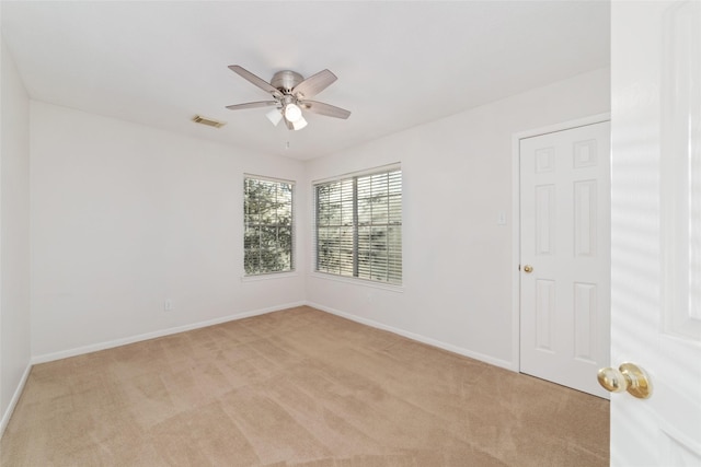 unfurnished room featuring ceiling fan and light colored carpet