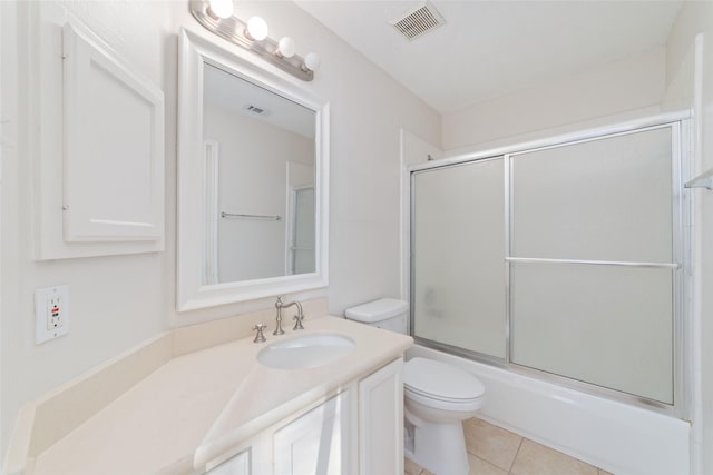 full bathroom with tile patterned floors, vanity, toilet, and shower / bath combination with glass door