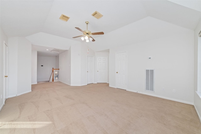 carpeted spare room with ceiling fan and vaulted ceiling