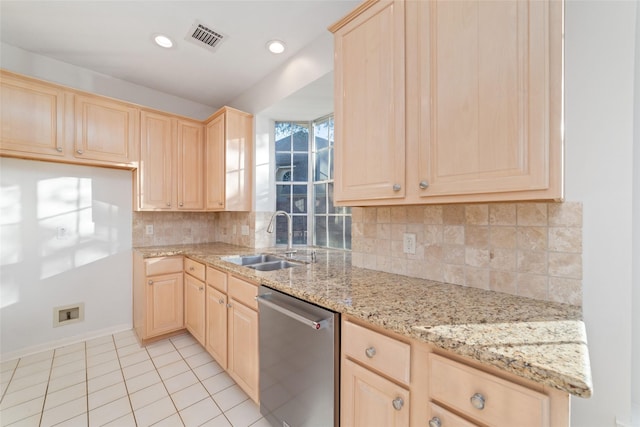 kitchen with dishwasher, light brown cabinetry, light stone countertops, and sink