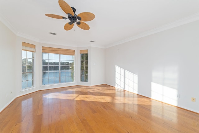 spare room with light hardwood / wood-style flooring, ceiling fan, and ornamental molding