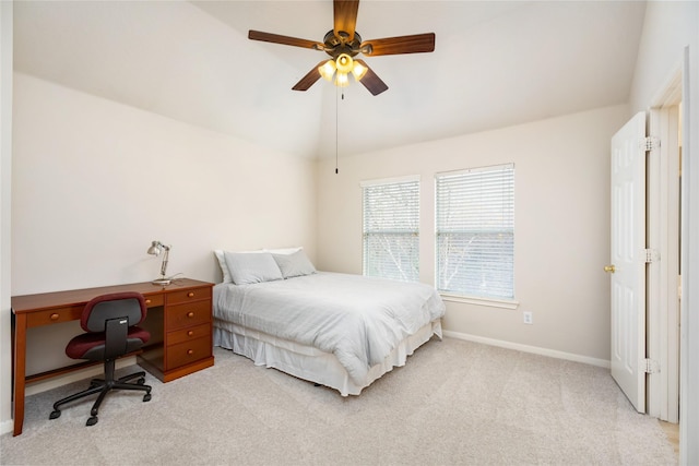 bedroom with ceiling fan, lofted ceiling, and light carpet