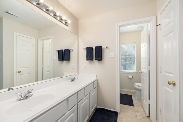 bathroom with vanity, toilet, and tile patterned flooring