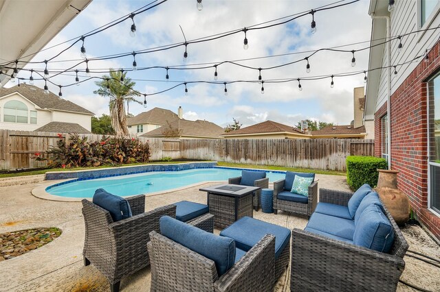 view of pool with an outdoor living space and a patio area