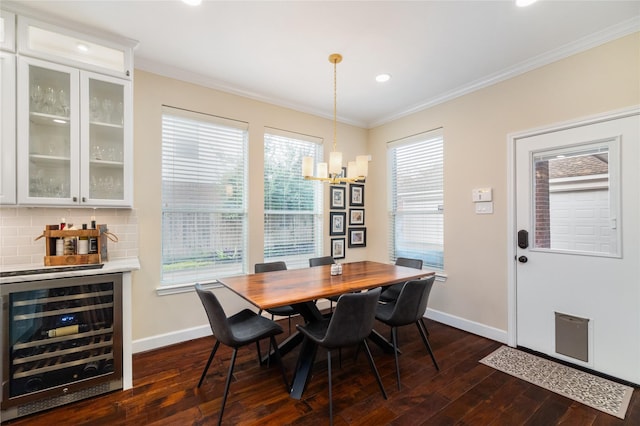 dining area featuring a notable chandelier, ornamental molding, dark hardwood / wood-style floors, and beverage cooler