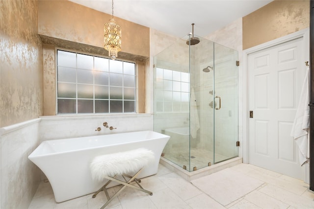 bathroom with shower with separate bathtub and a chandelier