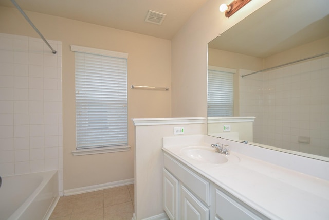 bathroom featuring vanity, tile patterned floors, and tiled shower / bath combo