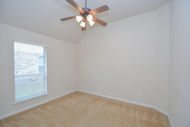 carpeted spare room featuring ceiling fan and vaulted ceiling