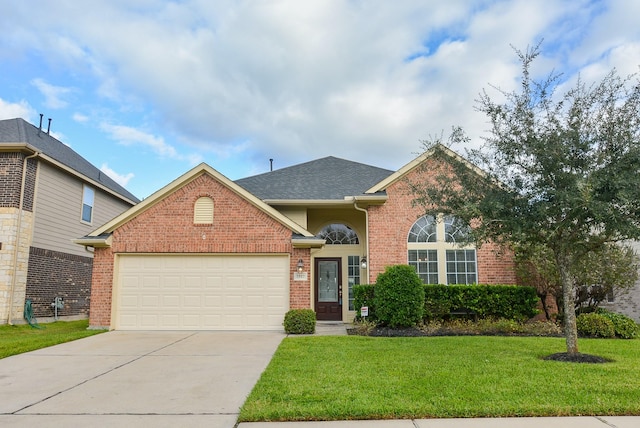 front facade with a front yard and a garage