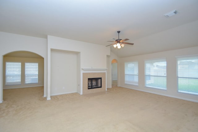 unfurnished living room featuring ceiling fan, light colored carpet, and lofted ceiling