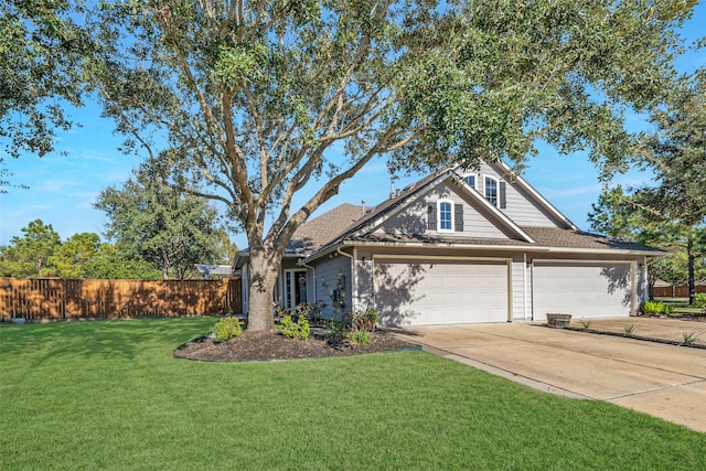 view of front of house with a garage and a front lawn