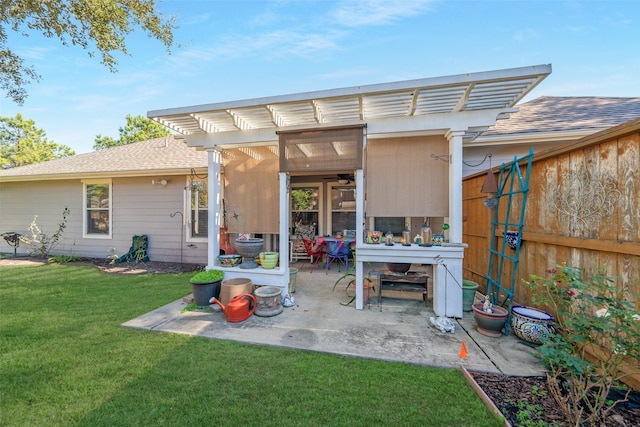 back of house with a lawn, a patio area, and a pergola