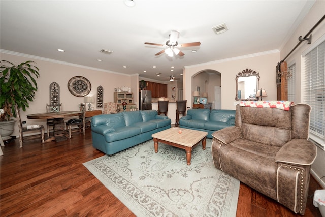 living room with ceiling fan, dark hardwood / wood-style flooring, and crown molding