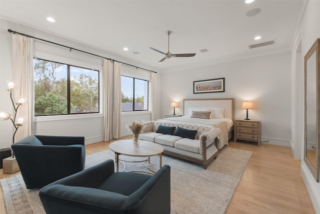 bedroom featuring ceiling fan, light hardwood / wood-style flooring, and ornamental molding