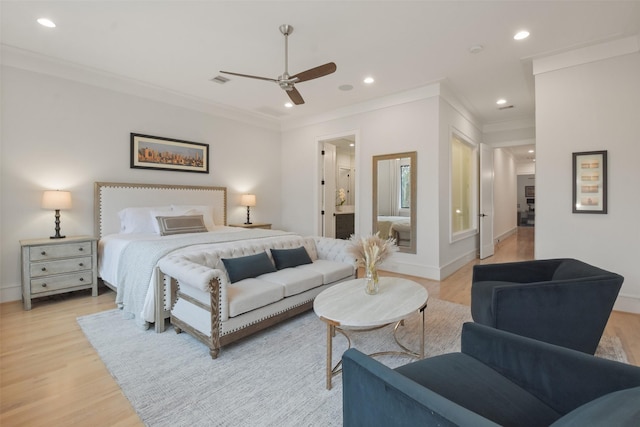 bedroom with ceiling fan, light wood-type flooring, crown molding, and ensuite bath