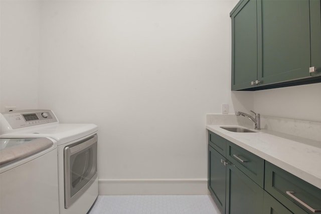 laundry room with sink, light tile patterned flooring, cabinets, and independent washer and dryer