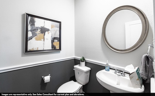 bathroom featuring toilet and sink