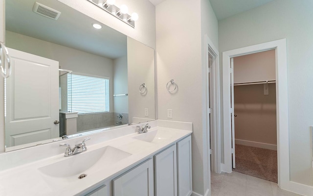2319 Ridgewood Dr, West Columbia, TX 77486 - full bath with double vanity, tile patterned floors, a spacious closet, and baseboards