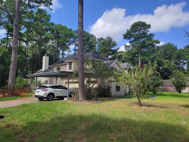 exterior space with a carport, a garage, and a yard