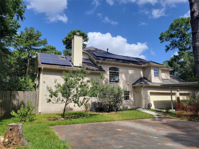 view of front facade with solar panels and a garage