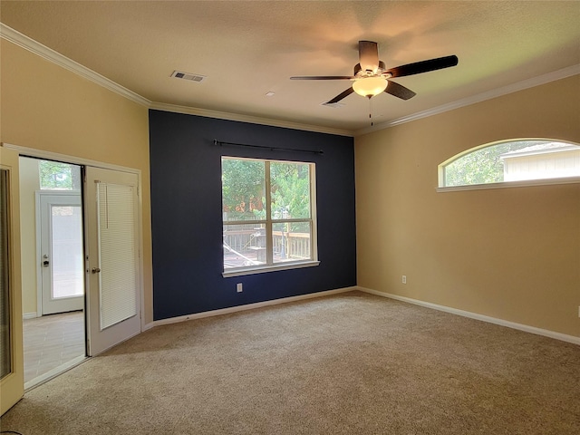 spare room featuring light carpet, french doors, ceiling fan, and ornamental molding