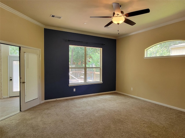 carpeted spare room with ceiling fan and ornamental molding