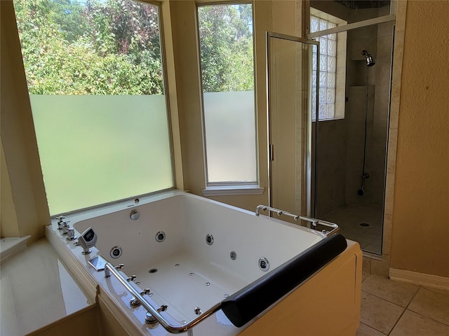 bathroom with separate shower and tub and tile patterned floors