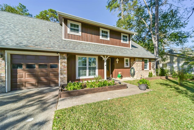 view of front of home with a front lawn and a garage