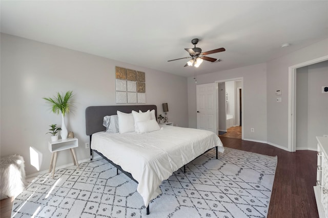 bedroom with ceiling fan, light hardwood / wood-style floors, and ensuite bath