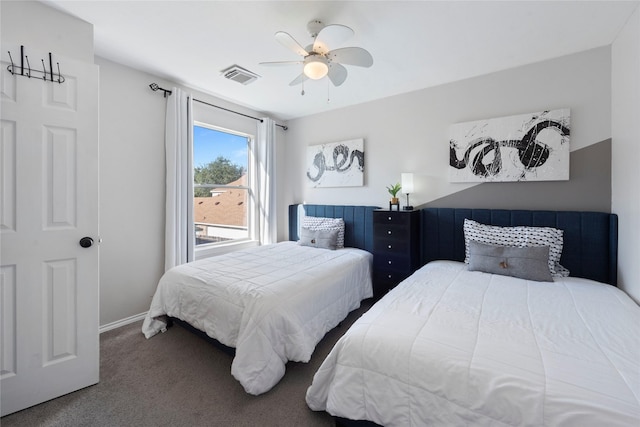 bedroom with ceiling fan and dark carpet