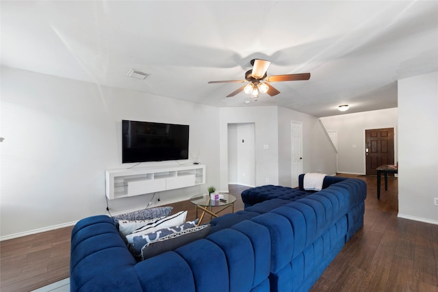 living room featuring ceiling fan and dark hardwood / wood-style floors