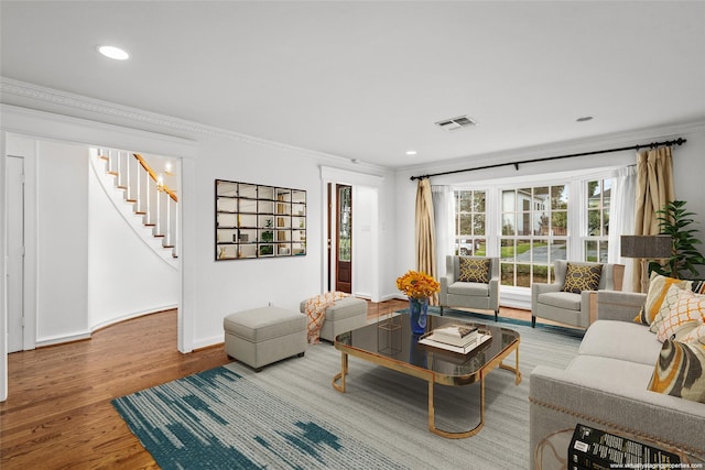 living room with crown molding and hardwood / wood-style floors