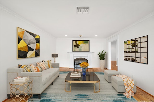 living room featuring hardwood / wood-style flooring and ornamental molding