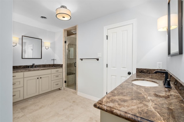 bathroom with vanity and a shower with shower door