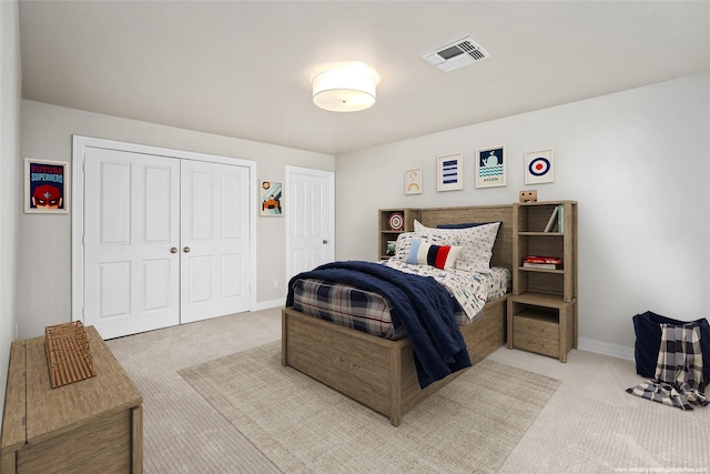 bedroom with light carpet and a closet