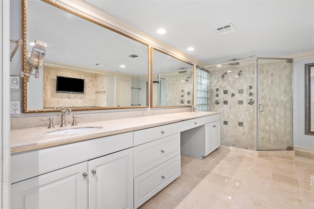 bathroom featuring tile patterned floors, crown molding, vanity, and a shower with shower door