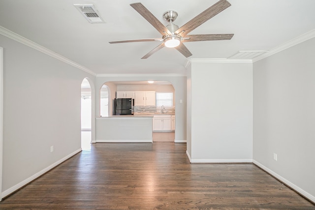 unfurnished living room featuring dark hardwood / wood-style flooring, ceiling fan, crown molding, and sink