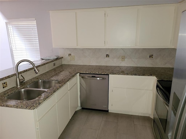 kitchen with dishwasher, stove, white cabinets, sink, and tasteful backsplash