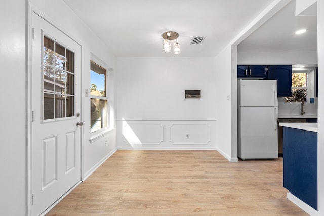 unfurnished dining area with light wood-type flooring and sink