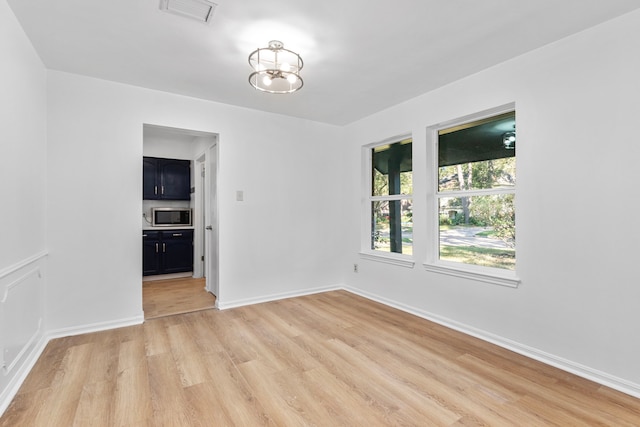 spare room featuring light wood-type flooring