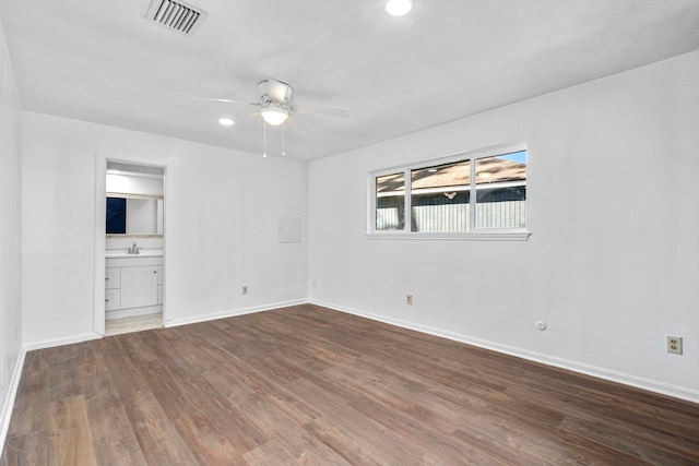 unfurnished room with hardwood / wood-style flooring, ceiling fan, and sink