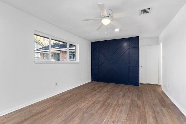 unfurnished room with hardwood / wood-style floors and ceiling fan